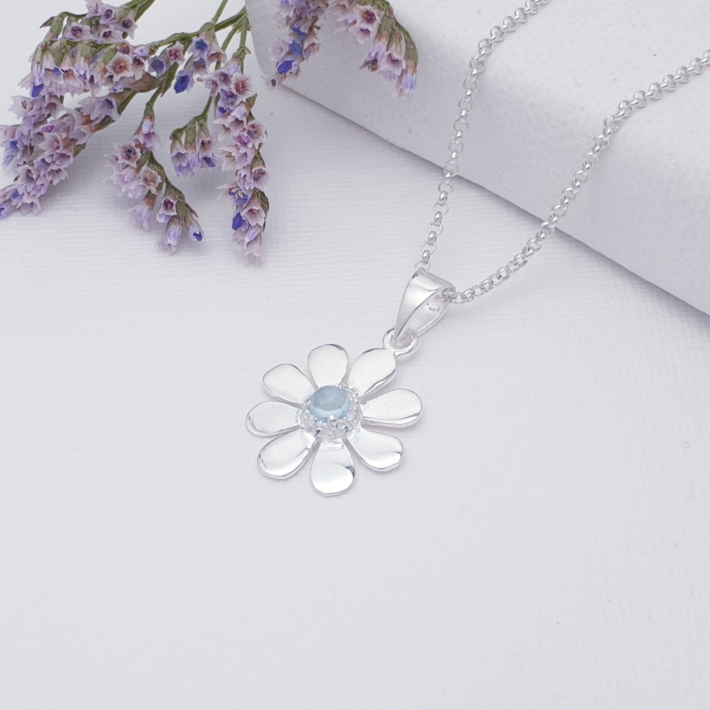 This pendant features a round cabochon Blue Topaz stone. The Blue Topaz stone is highlighted by decorative Silver petals creating a detailed daisy.  A beautiful little pendant, this is bound to become an everyday favourite.