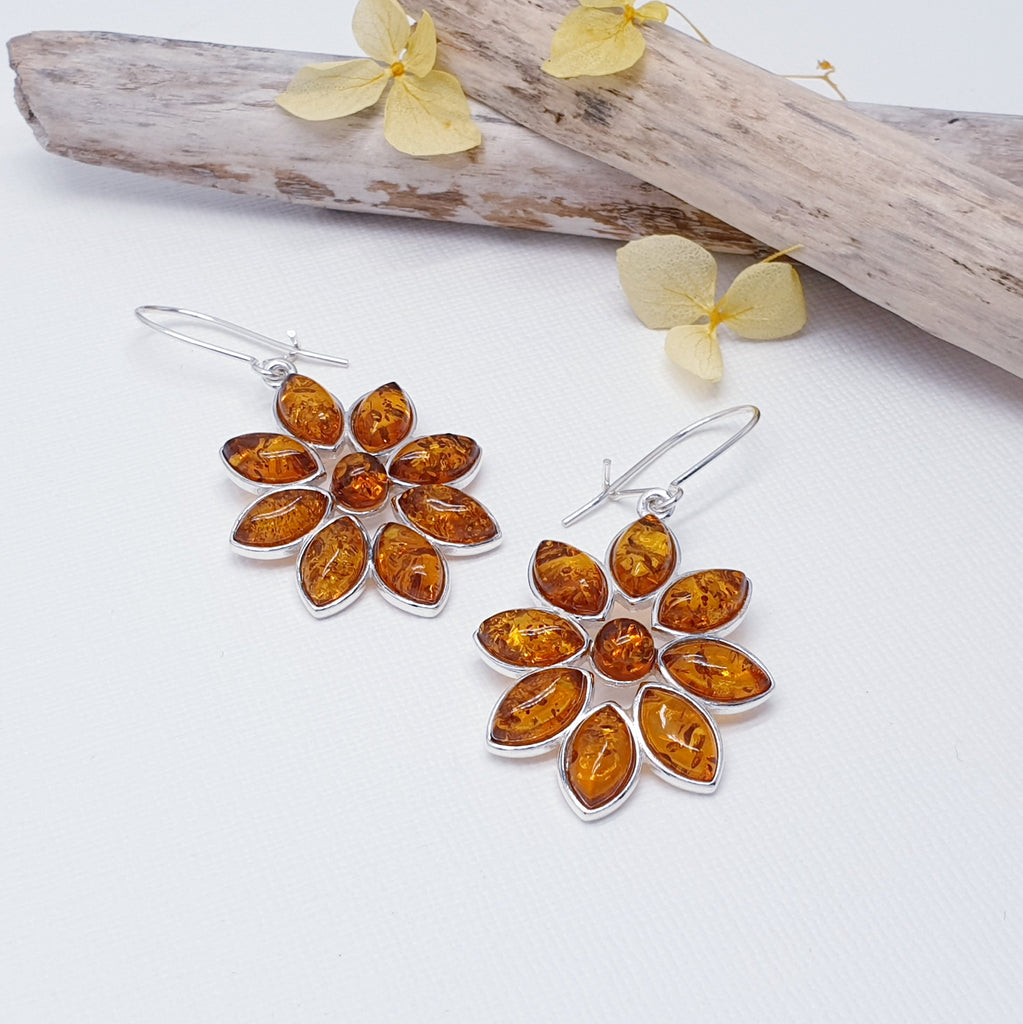 Each earring features eight beautiful marquise shaped Baltic Toffee Amber stones.  In a gorgeous flower shape, this adorable pair of earrings are exquisitely feminine and are sure to become your everyday favourites. A closed hook fastening means that they are extra secure so you won't have to worry about loosing them.