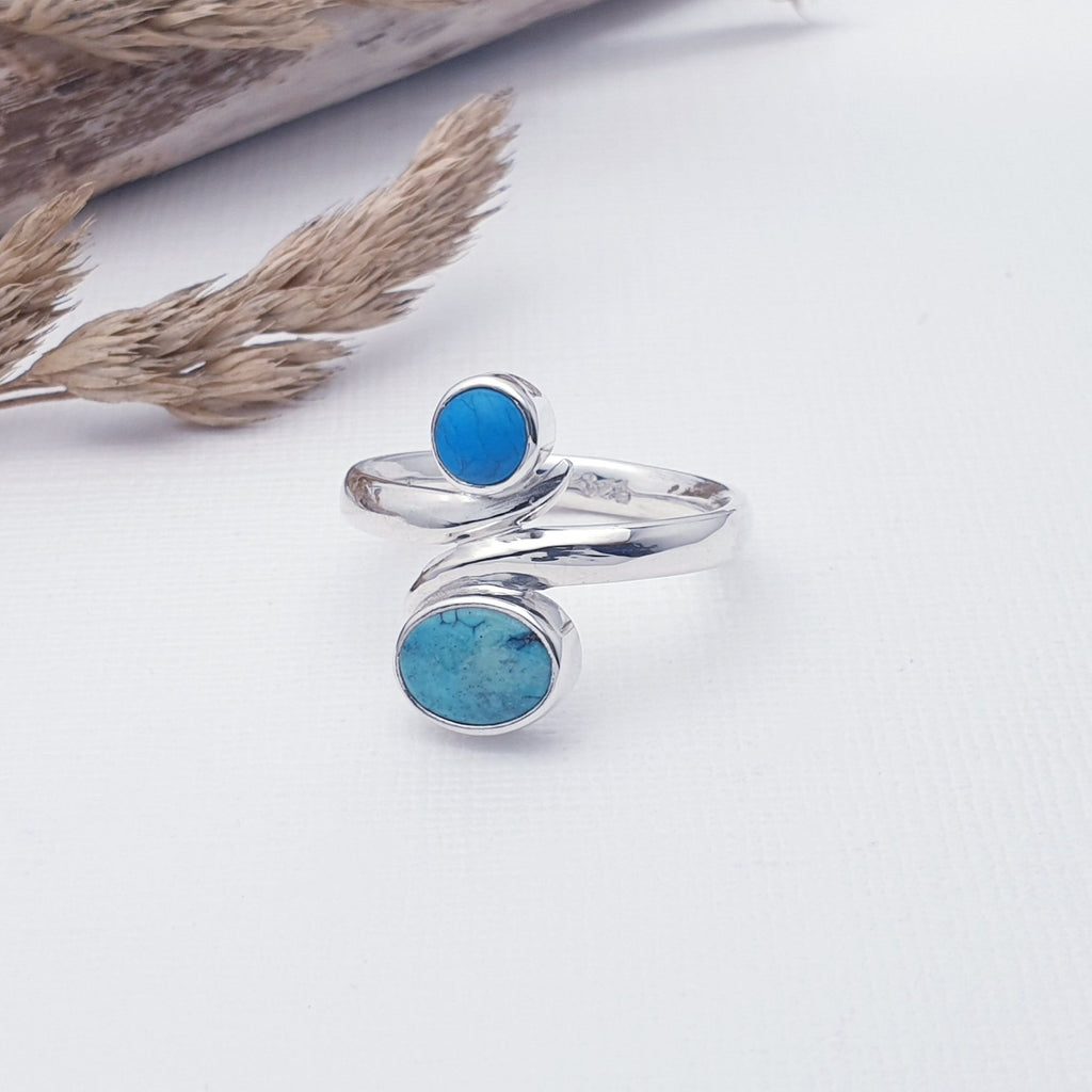 Our Turquoise Juno Ring is perfect for everyday wear or special occasions.  This beautiful ring features two table top cut, one oval and one round, Turquoise stones in Sterling Silver settings. The stones have been arranged one above the other, and the Sterling Silver band, gives this ring a wrap around feel. A gorgeous and simple design, this ring is bound to become an everyday favourite.