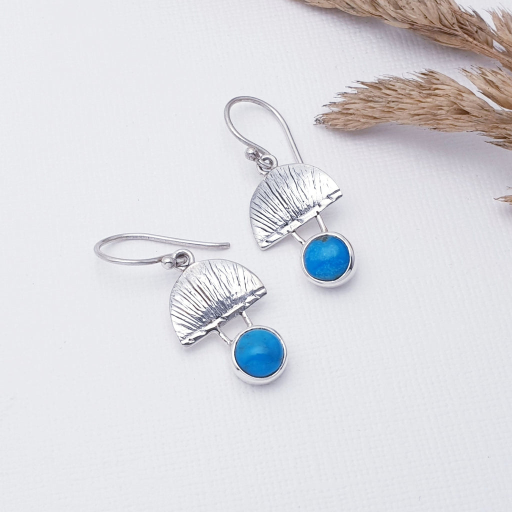 Our Turquoise Greek Goddess Earrings are perfect for everyday wear or special occasions.  Each earring features a half circle of Sterling Silver with beautiful hand etched detailing. Adding to the design, a gorgeous, cabachon, round, Turquoise stone sits beneath the half circle. Something a little different, these earrings will be a welcome addition to any jewellery box collection. 
