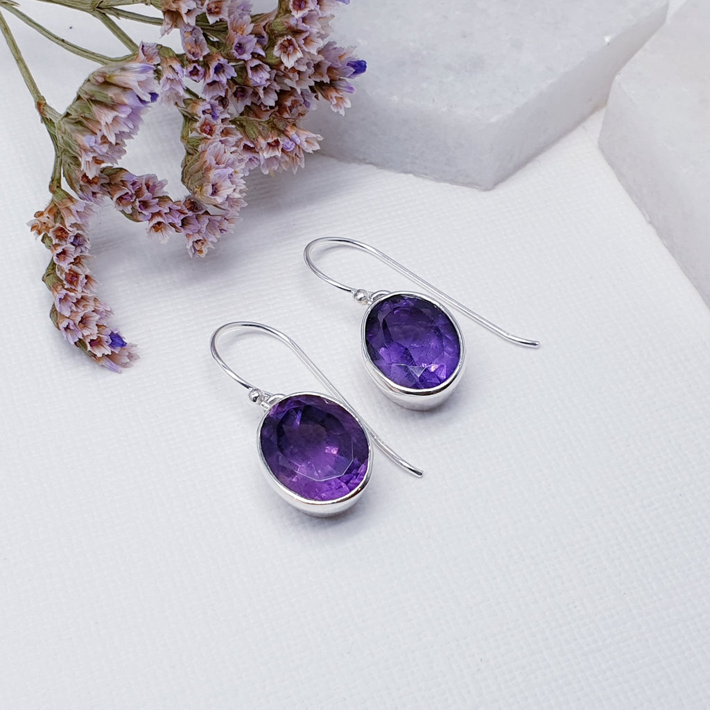 Our Amethyst Sterling Silver Oval Earrings are perfect for everyday wear or special occasions.  With an understated design, these earrings feature beautiful tabletop cut, oval, amethyst stones in simple Sterling silver settings. Nice and simple, these little earrings are the perfect complement to any outfit or occasion.