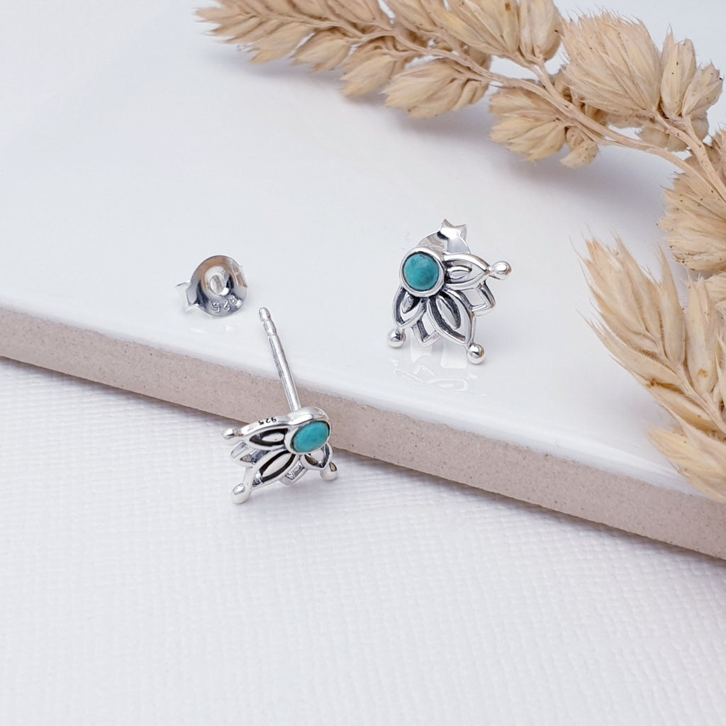 Our Sterling Silver Turquoise Lotus Flower Studs are perfect for every day wear.   These earrings feature tiny round Turquoise stones, that are framed by intricate Sterling Silver detailing, giving the impression of a lotus flower.