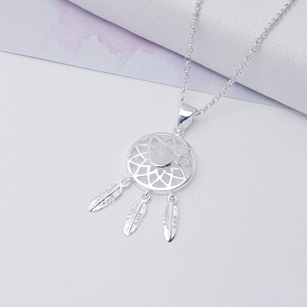 Our Moonstone Sterling Silver Dream Catcher Pendant (chain not included) is so cute as would be and perfect for everyday wear.  This stunning pendant features small, cabochon Moonstone in the center of a beautifully detailed dream catcher, with three dangly feathers. This pendant is dainty and is ideal for women and girls of all ages.