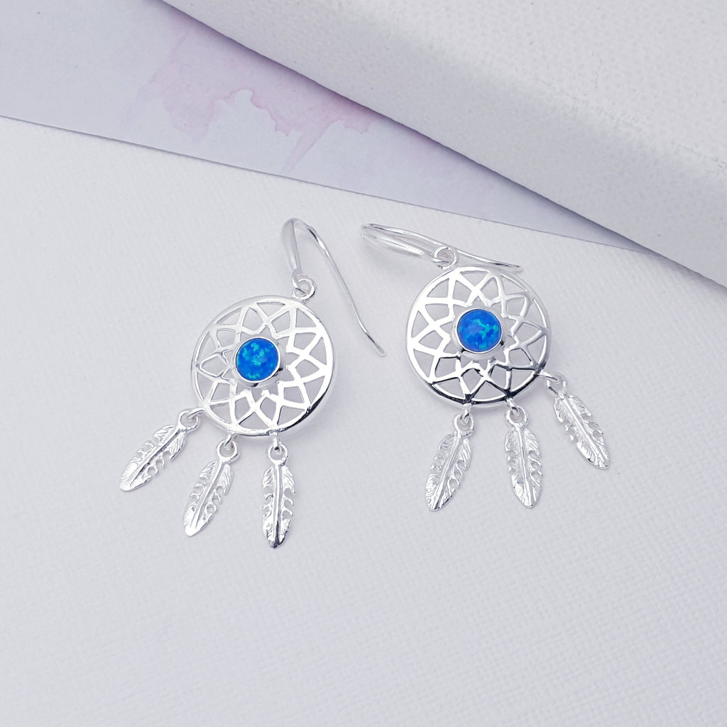 Our Reconstituted Opal Sterling Silver Dream Catcher Earrings are perfect for everyday wear or special occasions.  These stunning earrings features small, cabochon Reconstituted Opals in the center of a beautifully detailed dream catcher, with three dangly feathers. 