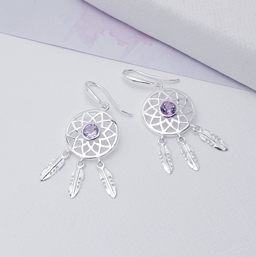 Our Amethyst Sterling Silver Dream Catcher Earrings are perfect for everyday wear or special occasions.  These stunning earrings features small, cabochon Amethysts in the center of a beautifully detailed dream catcher, with three dangly feathers.