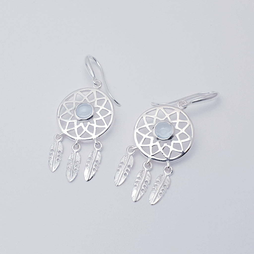 Our Blue Topaz Sterling Silver Dream Catcher Earrings are perfect for everyday wear or special occasions.  These stunning earrings features small, cabochon Blue Topaz' in the center of a beautifully detailed dream catcher, with three dangly feathers.