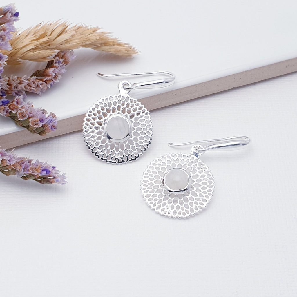 Our Moonstone Sterling Silver Dream Catcher Earrings are perfect for everyday wear or special occasions.  These stunning earrings feature small, cabochon Moonstone's in the center of a beautifully detailed flower.