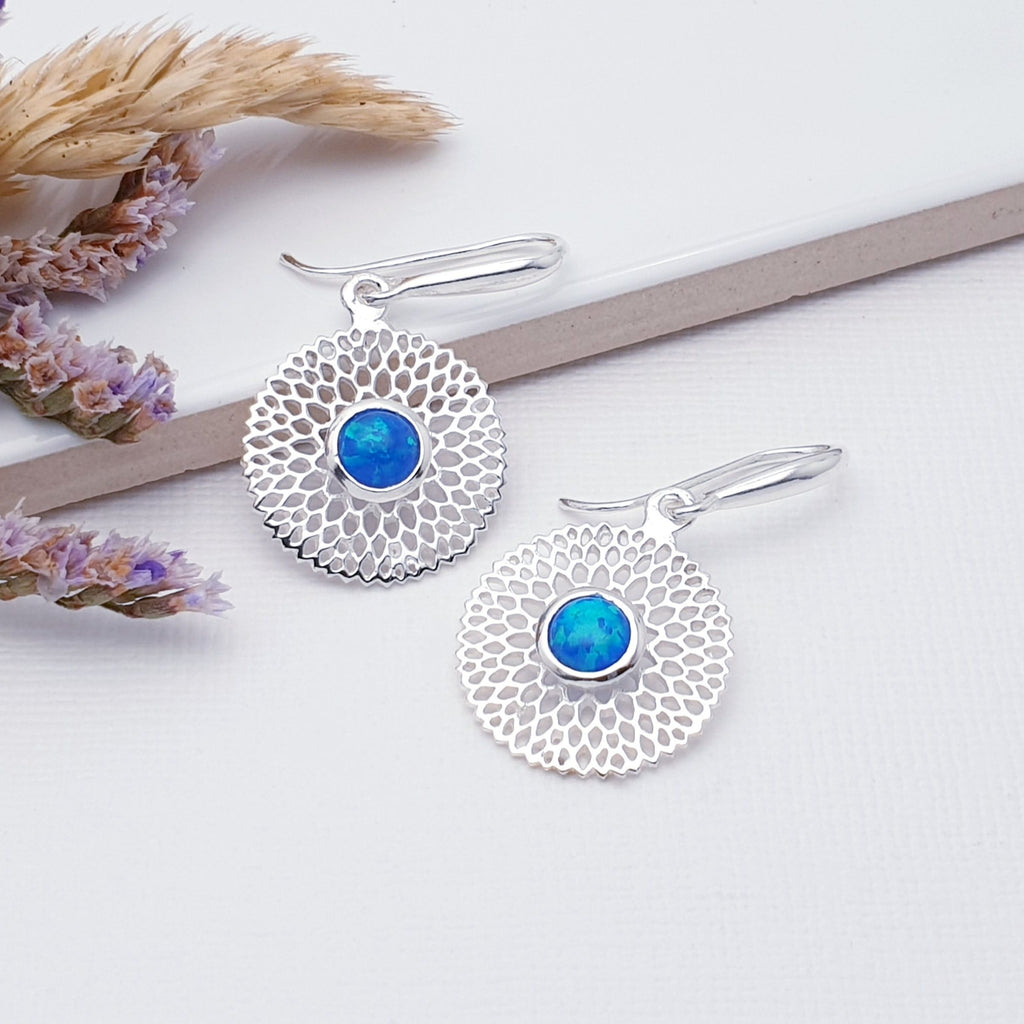 Our Reconstituted Opal Sterling Silver Dream Catcher Earrings are perfect for everyday wear or special occasions.  These stunning earrings feature small, cabochon Reconstituted Opals in the center of a beautifully detailed flower.