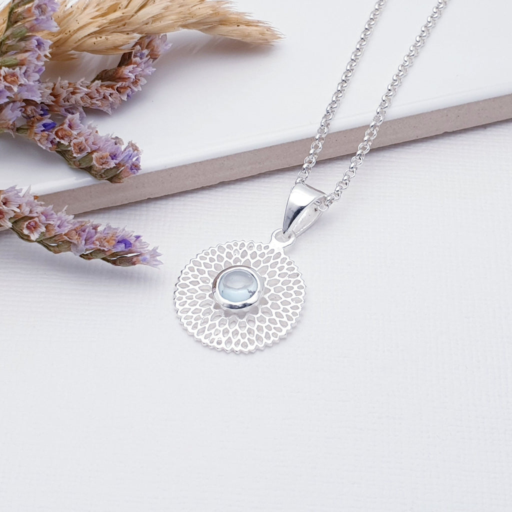 Our Blue Topaz Sterling Silver Chrysanthemum Pendant (chain not included) is so cute and would be perfect for everyday wear.  This stunning pendant features a small, cabochon Blue Topaz' in the center of a beautifully detailed flower.