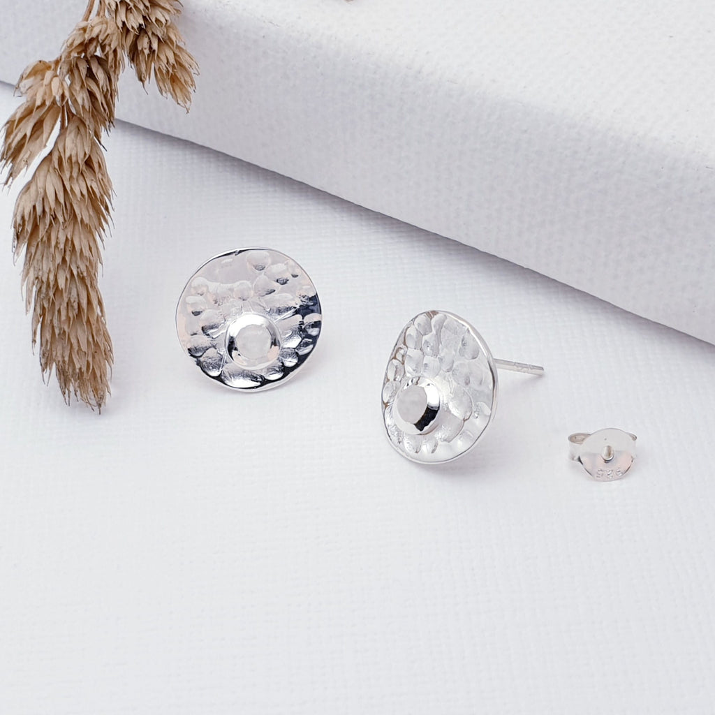 Our Sterling Silver Moonstone Hammered Disk Studs are perfect for every day wear.  Sometimes less is more, and that is definitely the case with this gorgeous pair of Moonstone studs. These stunning studs feature small, cabochon Moonstone's sitting off-center on a beautiful, hammered Sterling Silver disk. 